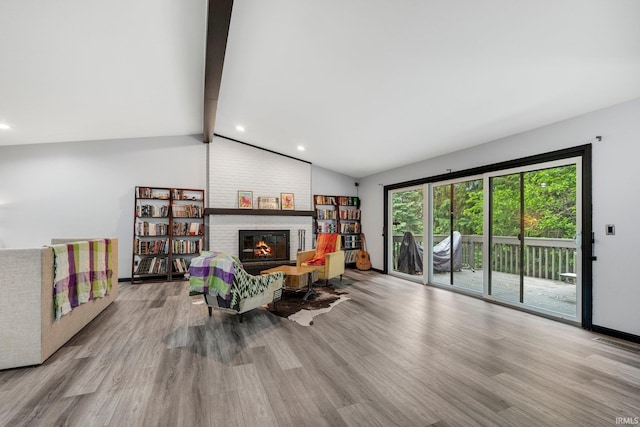 9531 Ledge Wood Ct, Fort Wayne, IN 46804 - living room featuring wood finished floors, a brick fireplace, recessed lighting, and baseboards