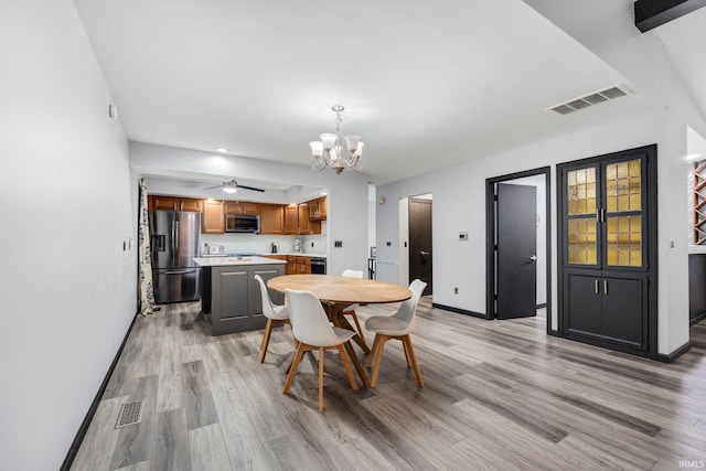 9531 Ledge Wood Ct, Fort Wayne, IN 46804 - dining space with a chandelier, light wood-type flooring, baseboards, and ceiling fan