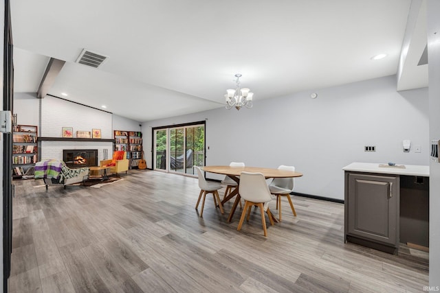 9531 Ledge Wood Ct, Fort Wayne, IN 46804 - dining room featuring light wood-style flooring, a chandelier, a brick fireplace, recessed lighting, and baseboards