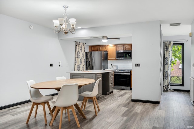9531 Ledge Wood Ct, Fort Wayne, IN 46804 - dining room featuring light wood-style flooring, a chandelier, and baseboards