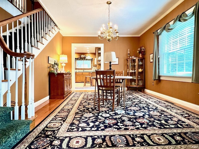 1405 19th St, Bedford, IN 47421 - dining space featuring ornamental molding, a chandelier, stairway, and baseboards