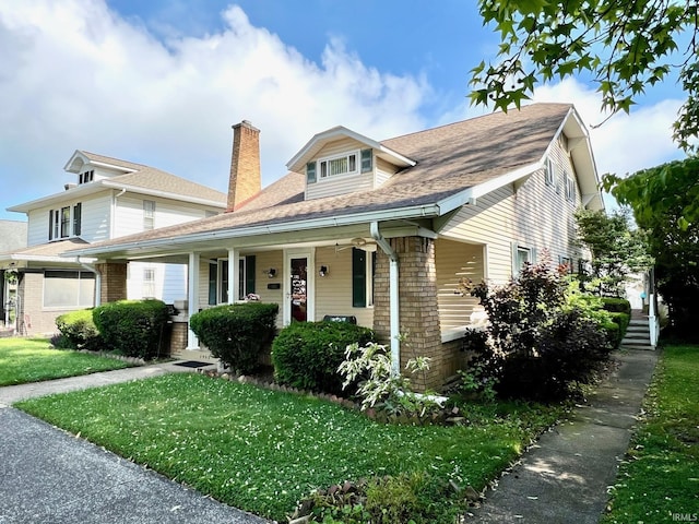 1405 19th St, Bedford, IN 47421 - bungalow featuring a porch, a front yard, a chimney, and roof with shingles