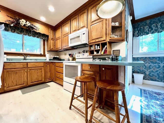 1405 19th St, Bedford, IN 47421 - kitchen with white appliances, brown cabinetry, crown molding, wallpapered walls, and light wood-style floors