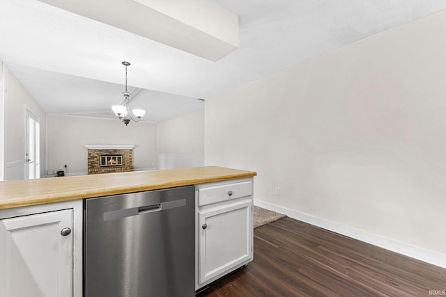 6420 Londonderry Ln, Fort Wayne, IN 46835 - kitchen featuring stainless steel dishwasher, dark wood-type flooring, lofted ceiling, white cabinetry, and baseboards