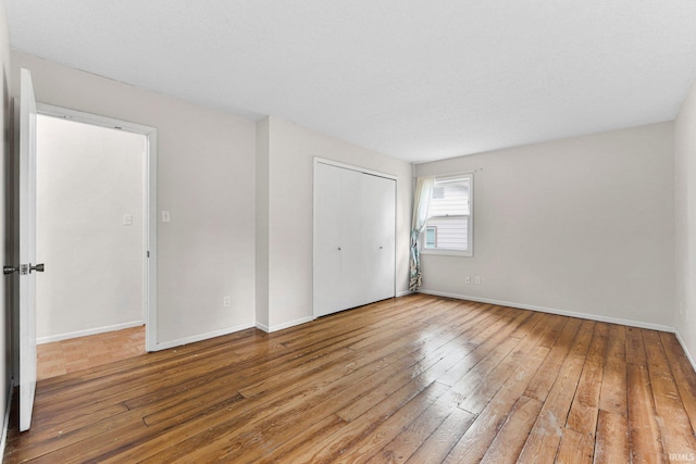 6420 Londonderry Ln, Fort Wayne, IN 46835 - unfurnished bedroom with hardwood / wood-style flooring, baseboards, and a closet