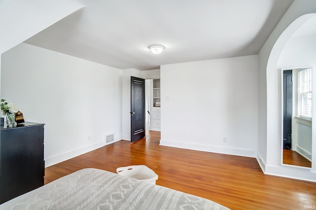 1920 Kenwood Ave, Fort Wayne, IN 46805 - bedroom featuring arched walkways, wood finished floors, and baseboards