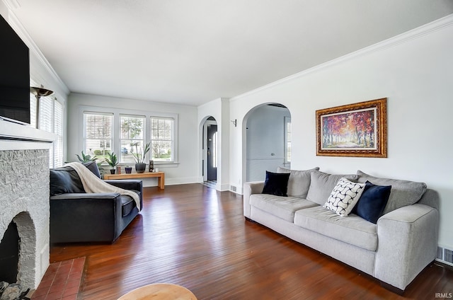 1920 Kenwood Ave, Fort Wayne, IN 46805 - living room with arched walkways, wood finished floors, ornamental molding, baseboards, and a stone fireplace
