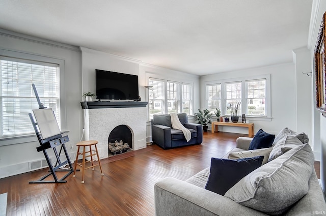 1920 Kenwood Ave, Fort Wayne, IN 46805 - living area with healthy amount of natural light, wood finished floors, a fireplace, ornamental molding, and baseboards