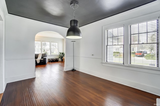 1920 Kenwood Ave, Fort Wayne, IN 46805 - dining space featuring arched walkways, dark wood-type flooring, and baseboards