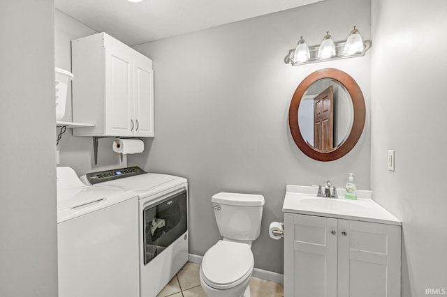 54062 Stonebridge Dr, Elkhart, IN 46514 - bathroom featuring washing machine and dryer, vanity, toilet, and tile patterned flooring