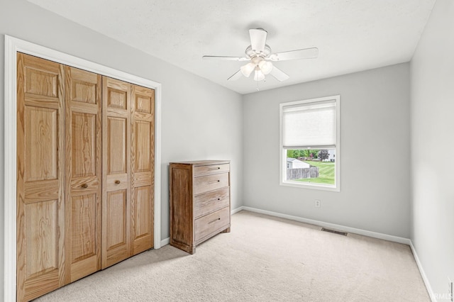 54062 Stonebridge Dr, Elkhart, IN 46514 - unfurnished bedroom with light carpet, baseboards, a closet, and ceiling fan