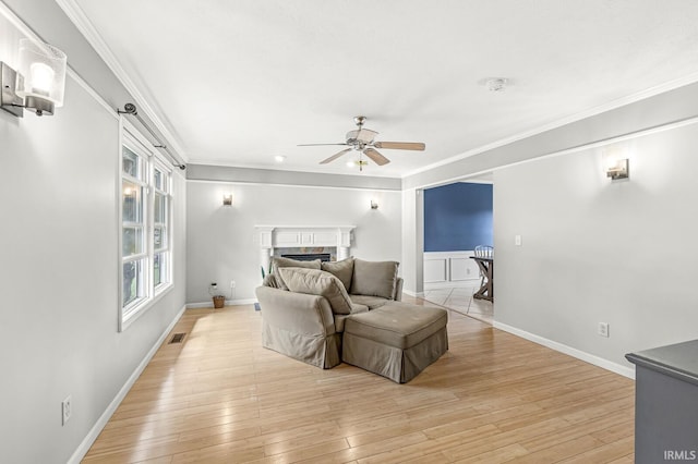 54062 Stonebridge Dr, Elkhart, IN 46514 - bedroom with a fireplace, ornamental molding, light wood-type flooring, baseboards, and a ceiling fan