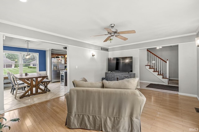 54062 Stonebridge Dr, Elkhart, IN 46514 - living room featuring stairway, ceiling fan, light wood finished floors, crown molding, and baseboards