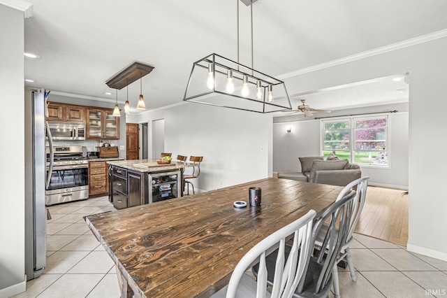 54062 Stonebridge Dr, Elkhart, IN 46514 - dining area with light tile patterned floors, crown molding, ceiling fan, recessed lighting, and wine cooler