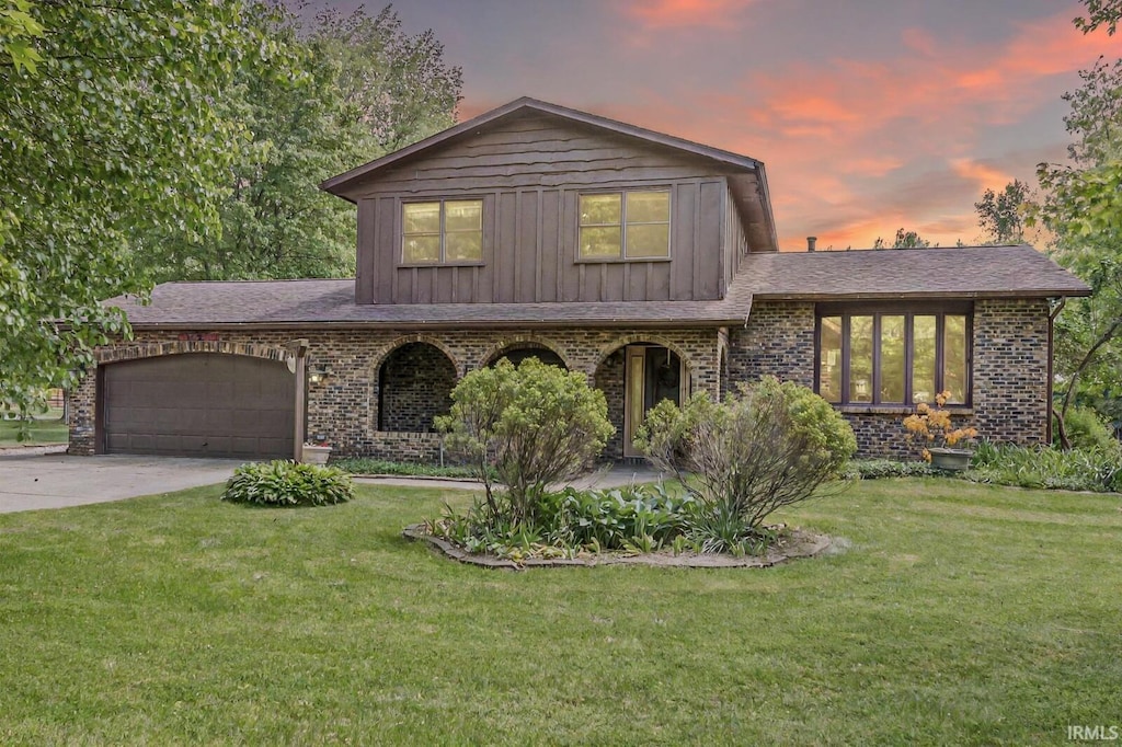 14104 Day Rd, Mishawaka, IN 46545 - split level home featuring brick siding, a yard, a garage, and driveway