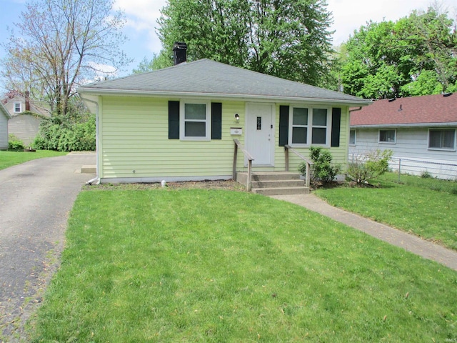 1103 S Jersey Ave, Muncie, IN 47302 - view of front of house with asphalt driveway, a chimney, and a front yard