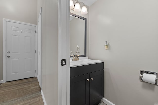 2106 Bayside Ct, Fort Wayne, IN 46804 - bathroom with baseboards, vanity, and wood finished floors