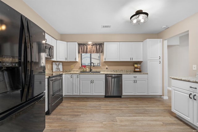 2106 Bayside Ct, Fort Wayne, IN 46804 - kitchen featuring black appliances, a sink, white cabinetry, and light wood-style floors