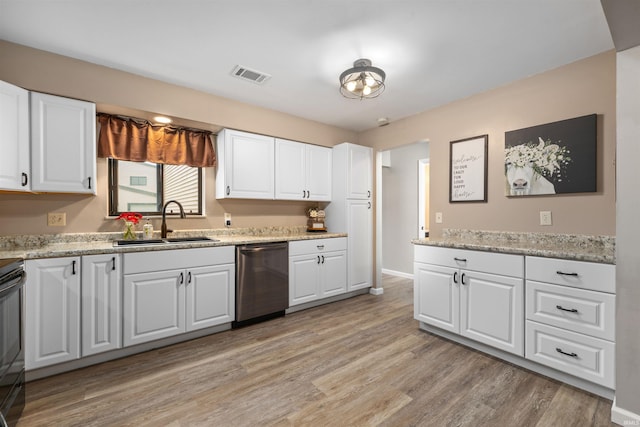 2106 Bayside Ct, Fort Wayne, IN 46804 - kitchen featuring dishwasher, a sink, light wood-type flooring, and white cabinets