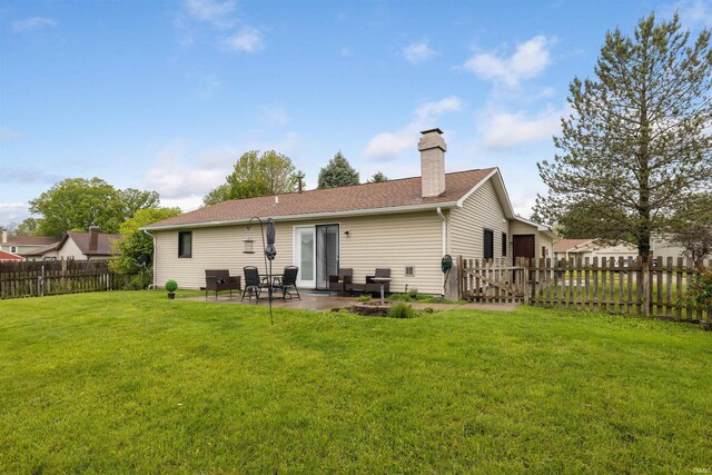 6008 Hinsdale Ln, Fort Wayne, IN 46835 - back of property with a patio area, a chimney, and roof with shingles