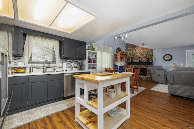 6008 Hinsdale Ln, Fort Wayne, IN 46835 - kitchen with a sink, stainless steel dishwasher, dark wood-type flooring, light countertops, and open floor plan