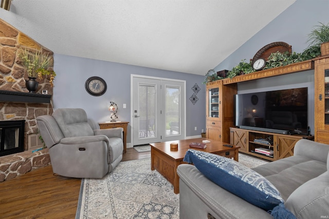 6008 Hinsdale Ln, Fort Wayne, IN 46835 - living room with lofted ceiling, wood finished floors, a stone fireplace, and baseboards