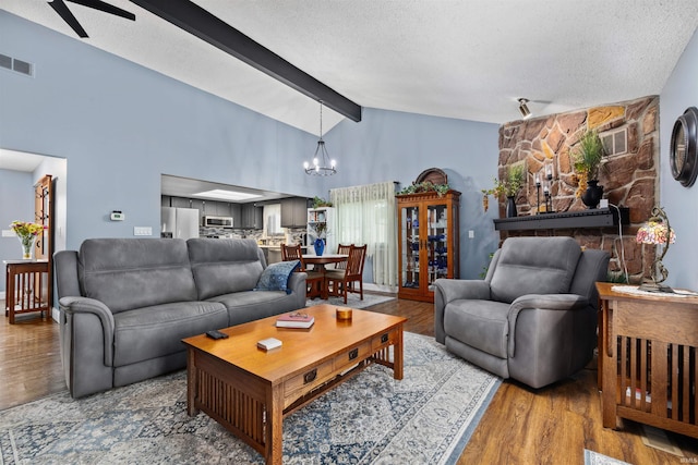 6008 Hinsdale Ln, Fort Wayne, IN 46835 - living area featuring a chandelier, a textured ceiling, a ceiling fan, and wood finished floors