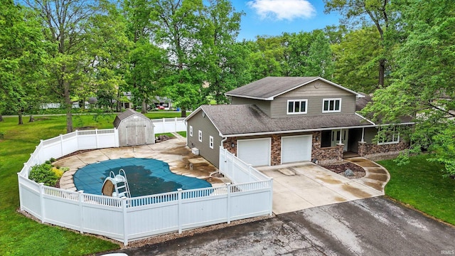 2882 E Hickory Ln, Columbia City, IN 46725 - view of front of house with driveway, stone siding, and roof with shingles