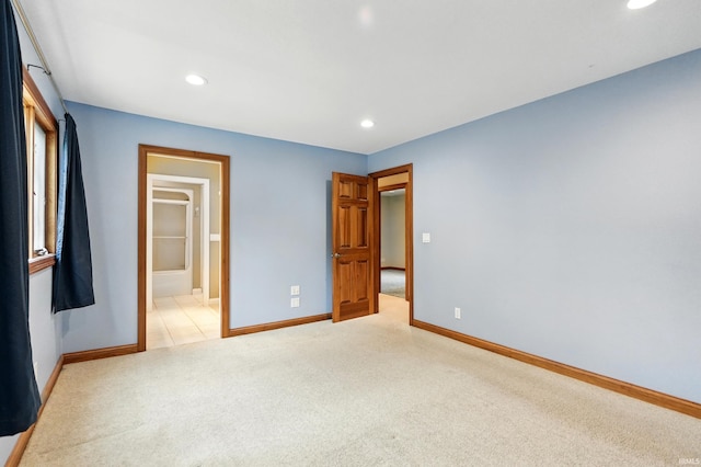 2882 E Hickory Ln, Columbia City, IN 46725 - unfurnished bedroom with light colored carpet, recessed lighting, baseboards, and ensuite bathroom