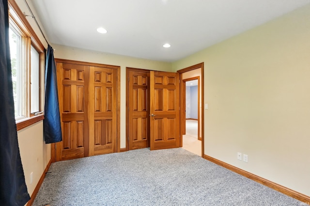 2882 E Hickory Ln, Columbia City, IN 46725 - unfurnished bedroom featuring multiple closets, carpet flooring, baseboards, and recessed lighting