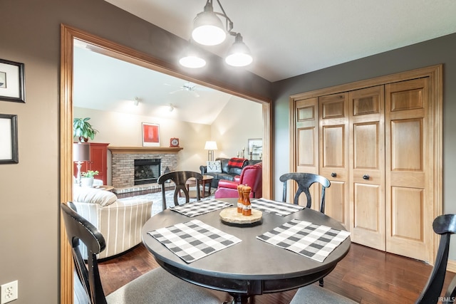8505 Crenshaw Ct, Fort Wayne, IN 46835 - dining area with ceiling fan, a brick fireplace, dark wood-style floors, and lofted ceiling