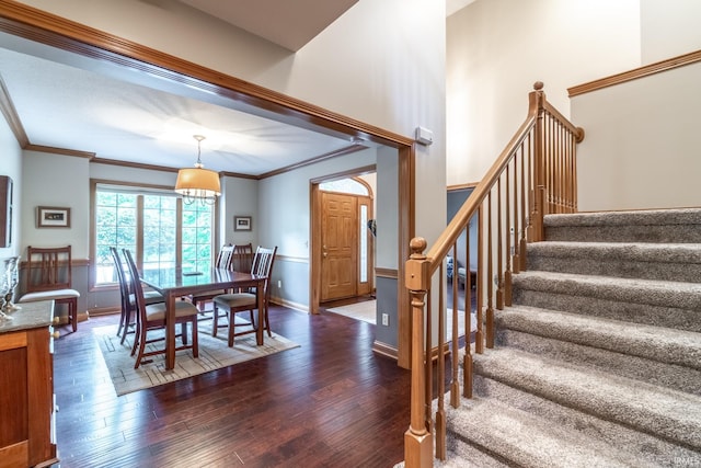 8505 Crenshaw Ct, Fort Wayne, IN 46835 - dining space featuring stairs, dark wood-type flooring, crown molding, and baseboards