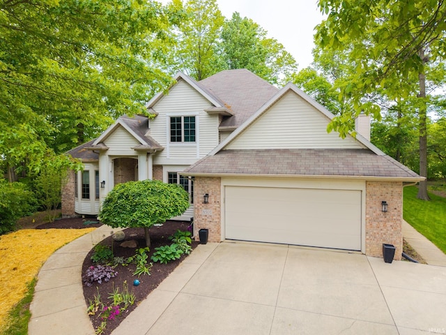 8505 Crenshaw Ct, Fort Wayne, IN 46835 - view of front facade with brick siding, concrete driveway, a garage, and a chimney