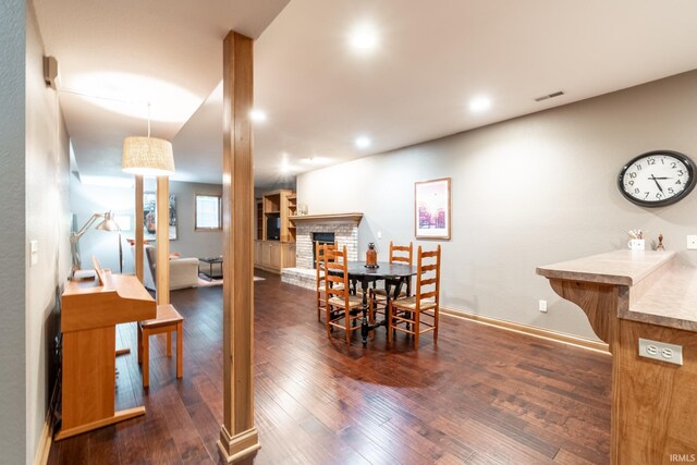 8505 Crenshaw Ct, Fort Wayne, IN 46835 - dining room with dark wood-type flooring, a brick fireplace, recessed lighting, and baseboards