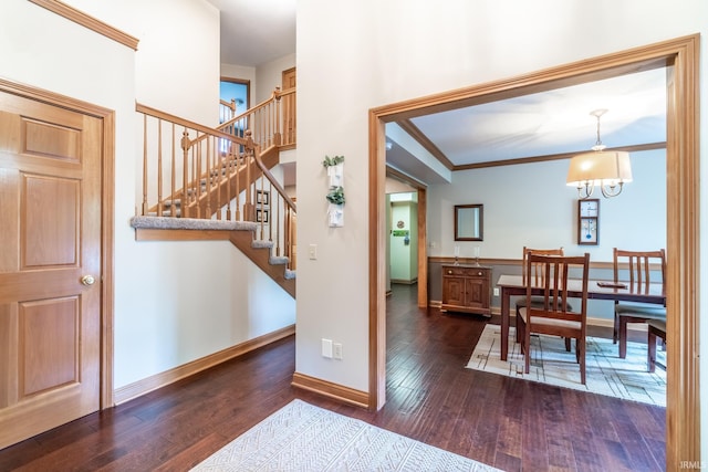 8505 Crenshaw Ct, Fort Wayne, IN 46835 - foyer featuring hardwood / wood-style flooring, stairs, baseboards, crown molding, and a chandelier