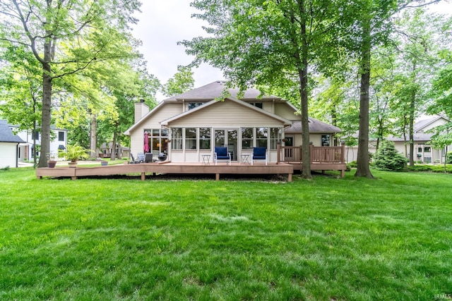 8505 Crenshaw Ct, Fort Wayne, IN 46835 - rear view of house featuring a chimney, a lawn, a deck, and a sunroom
