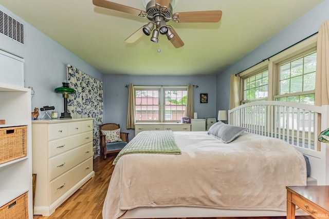 3400 W Petty Rd, Muncie, IN 47304 - bedroom featuring multiple windows, wood finished floors, and a ceiling fan