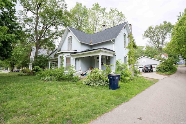 430 S Columbia St, Warsaw, IN 46580 - view of front of home with a chimney, a front lawn, roof with shingles, and a detached garage