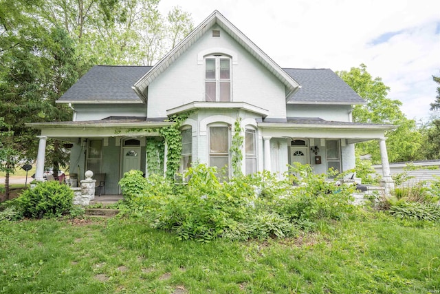 430 S Columbia St, Warsaw, IN 46580 - victorian-style house featuring covered porch, a shingled roof, and brick siding