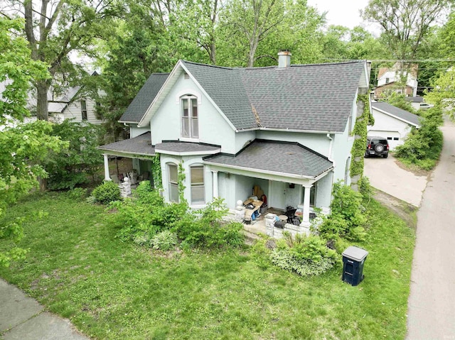 430 S Columbia St, Warsaw, IN 46580 - victorian-style house featuring roof with shingles, a chimney, stucco siding, and a front yard