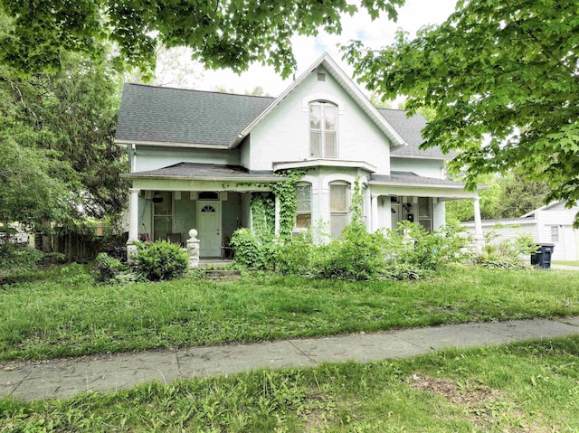 430 S Columbia St, Warsaw, IN 46580 - victorian house with a shingled roof, covered porch, and stucco siding