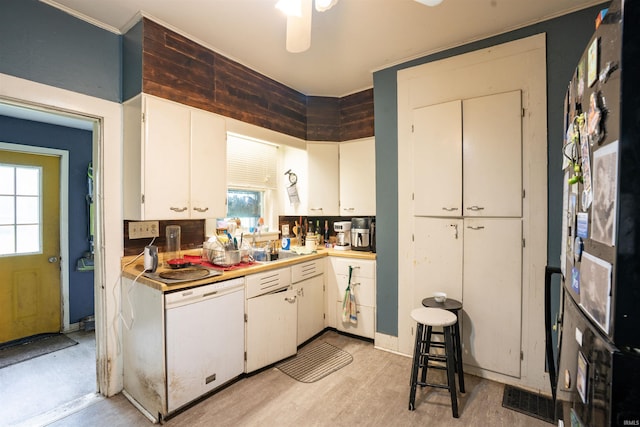 430 S Columbia St, Warsaw, IN 46580 - kitchen with light countertops, white dishwasher, ceiling fan, and light wood-style floors