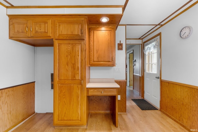 5460 N 550 E, Churubusco, IN 46723 - kitchen featuring light wood-style flooring, wainscoting, wooden walls, light countertops, and brown cabinetry