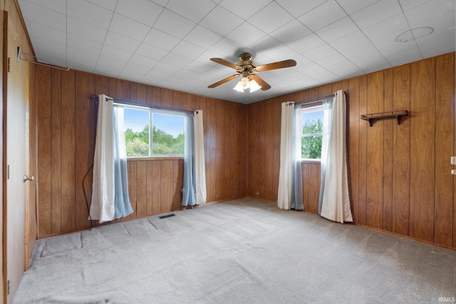 5460 N 550 E, Churubusco, IN 46723 - spare room with healthy amount of natural light, light carpet, a ceiling fan, wood walls, and baseboards
