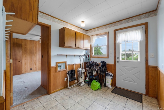 5460 N 550 E, Churubusco, IN 46723 - kitchen with a wainscoted wall, wood walls, brown cabinets, and light tile patterned floors