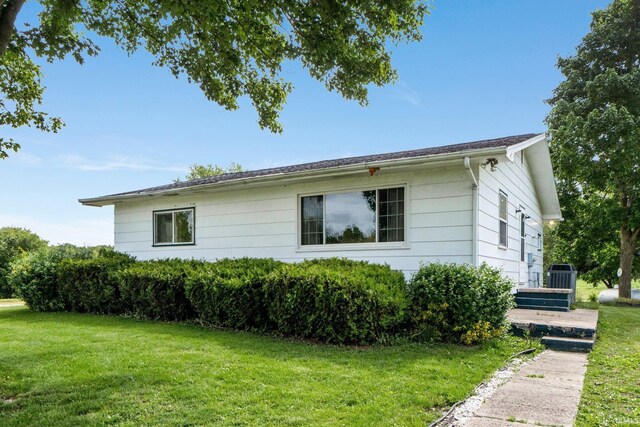 5460 N 550 E, Churubusco, IN 46723 - view of home's exterior with a yard and central AC unit