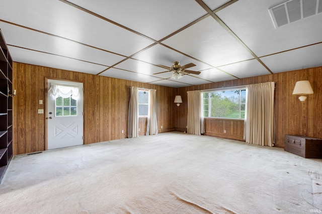 5460 N 550 E, Churubusco, IN 46723 - unfurnished living room with plenty of natural light, wooden walls, ceiling fan, and carpet