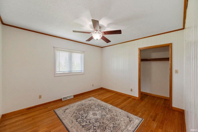 101 E Maple St, Fowler, IN 47944 - unfurnished bedroom with ornamental molding, light wood finished floors, baseboards, and a ceiling fan