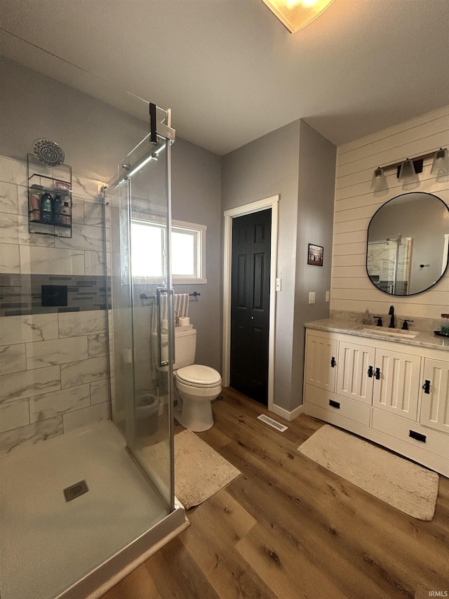 1301 E Spruce St, Petersburg, IN 47567 - full bath with wood finished floors, a shower stall, vanity, and toilet
