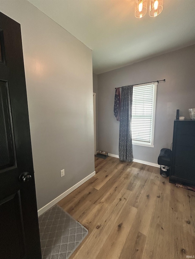 1301 E Spruce St, Petersburg, IN 47567 - interior space with baseboards, wood finished floors, and a chandelier